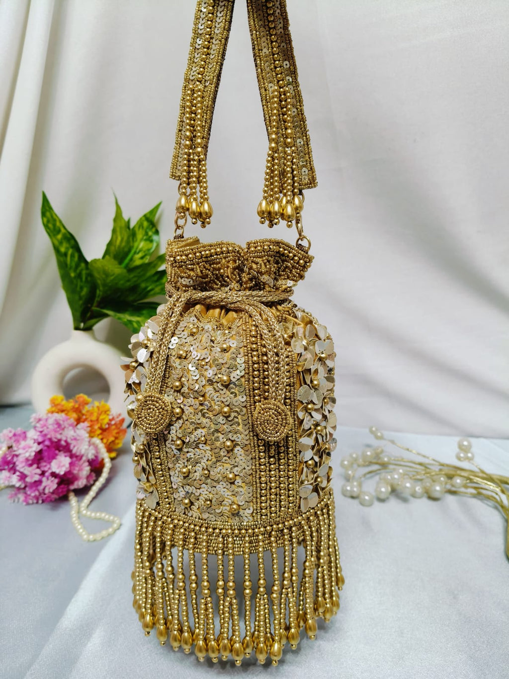 Golden dangling latkan potli bag